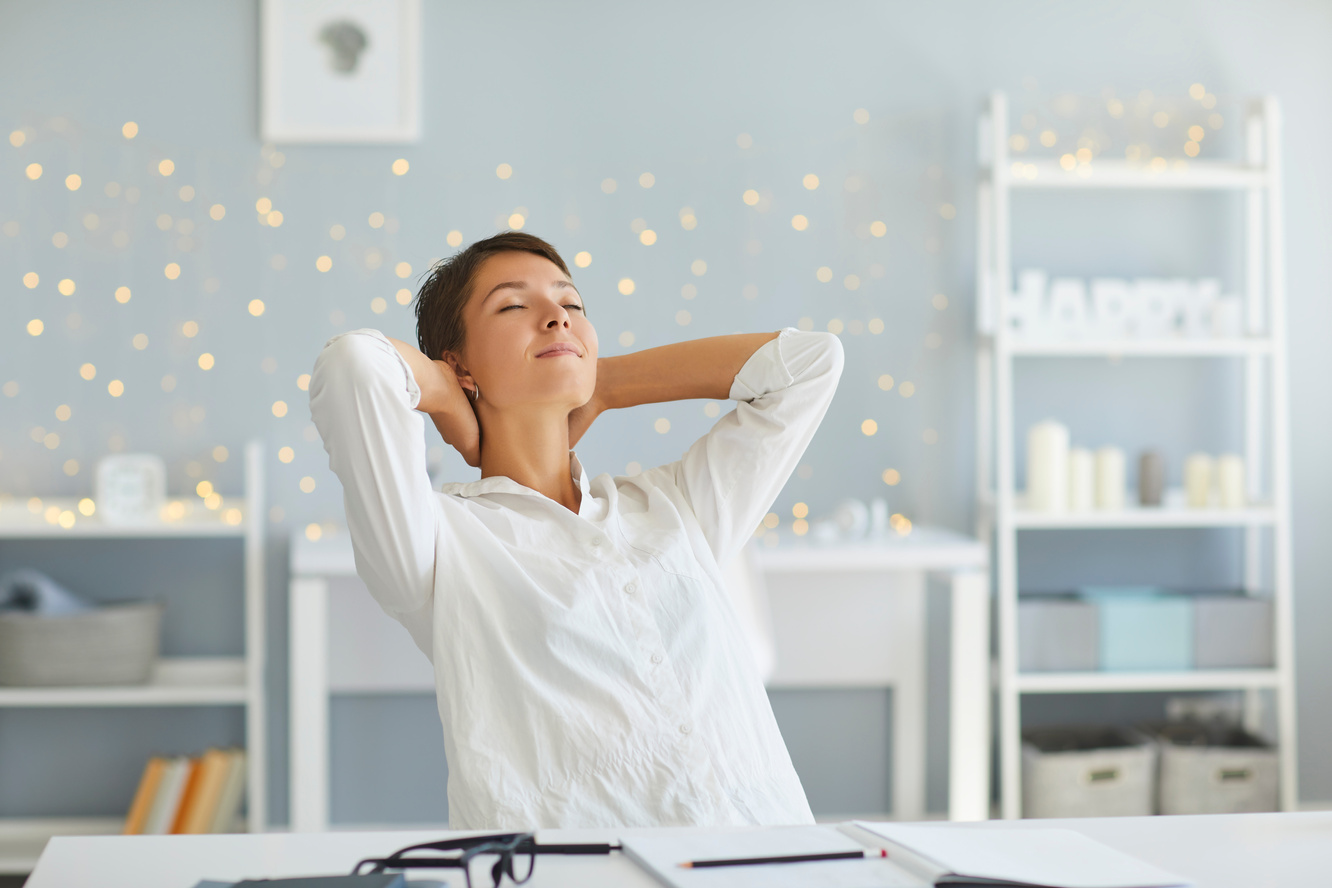 Relaxed Woman in Her Home Office Enjoying Great Sense of Achievement after Finishing All Daily Tasks